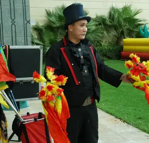 A magician is performing magic tricks at a Birthday party in Dubai.